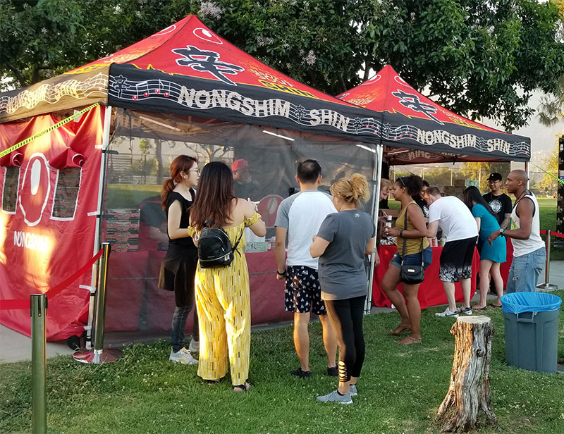 People gathering in front of the Nongshim Popup Event Tent